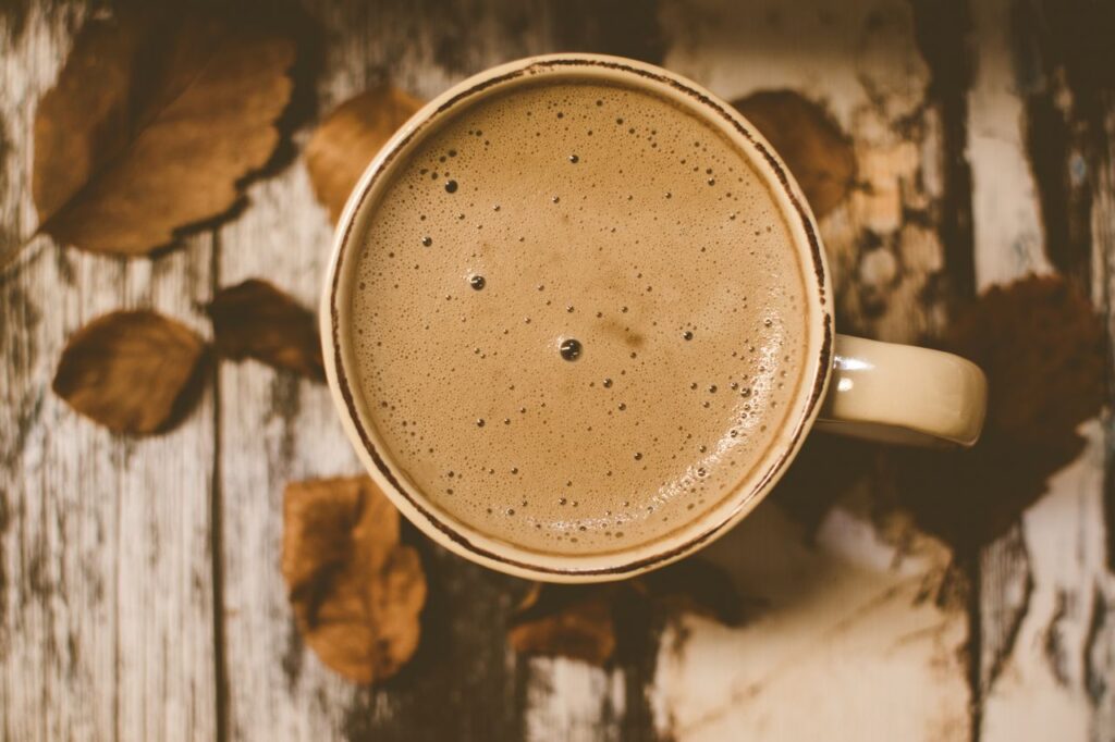Crafting Captivating Headlines: Your awesome post title goes here A rustic coffee mug sits on a wooden table surrounded by autumn leaves, creating a cozy atmosphere.